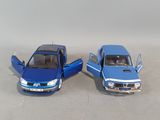 two toy cars sitting next to each other on a table