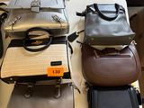 several purses are stacked on top of each other on a table