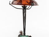 a table lamp with a glass shade on top of it
