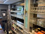 many glasses on the shelves in the kitchen