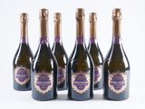 six bottles of champagne lined up in a row on a white surface