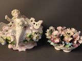 two figurines that are sitting next to each other
