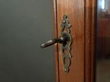 a close up of a door handle on a wooden door