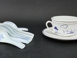 a cup and saucer sitting next to a spoon