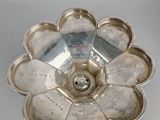 silver plated flower shaped candle holder on a white surface
