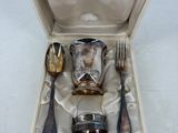 a box with silverware in it on a white surface