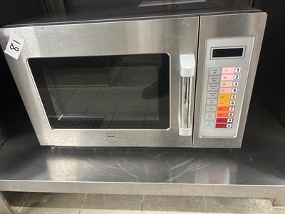 a silver microwave sitting on top of a metal counter