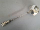 a silver spoon with a spoon handle on a table