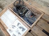 a box with a small engine in it on a pallet