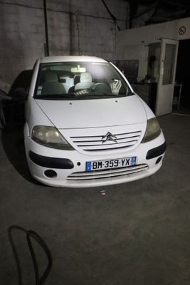 a picture of a white car parked in a garage