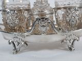 a silver tray with three glass jars on top of it