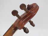 the back of a violin that is sitting on top of a wooden stand