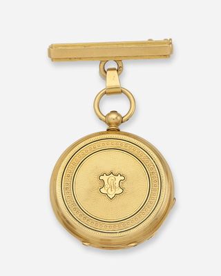 gros plan d'une montre de poche en or sur fond blanc