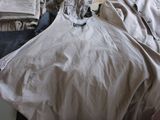 an image of a messy room with a bed and a fan