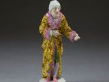 chinese figurine of an old woman in a yellow robe