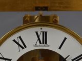a clock with roman numerals on the face of it