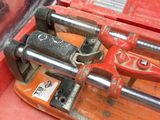 a red tool box with a couple of tools inside of it