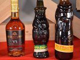 three bottles of alcohol sitting on a table next to each other