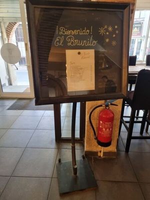a sign with a fire extinguisher in front of it