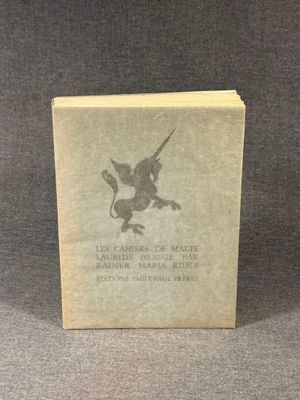 an old book sitting on top of a table next to a black and white photo