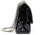 black purse with chain strap on a white background
