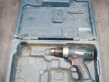 a drill in a case with a tool inside of it