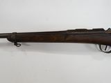 a rifle that is on display on a white surface