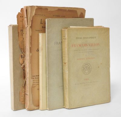 three old books are stacked on top of each other on a white surface