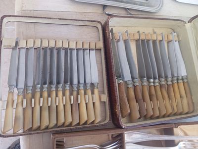many knives that are in a case on the table