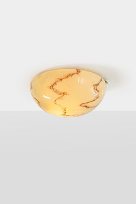 a close up of a piece of yellow marble on a white surface
