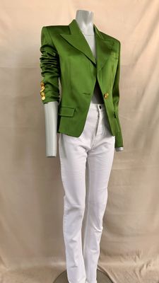 the mannequin is wearing a green jacket and white pants