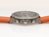 a close up of a watch with orange straps on a white surface