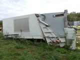 a white truck that is sitting in the grass