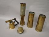 three brass vases and a lighter are sitting next to each other