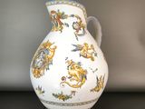 a white vase with a blue and yellow design on it