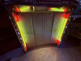 a juke box that is lit up with yellow and red lights