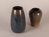 two vases sitting next to each other on a table