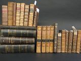 several old books stacked on top of each other on a table
