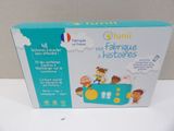 the box is open on a white surface with a picture of children in a toy car