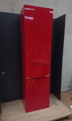a red refrigerator sitting on a pallet in a room