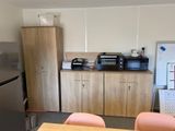a kitchen with a refrigerator, microwave, and a refrigerator freezer