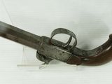 an old gun that is on display on a white surface