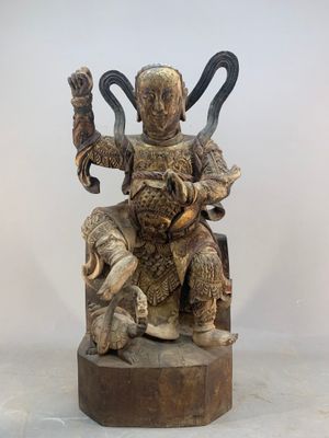 an image of a statue of a man sitting on top of a wooden block