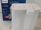 a white box and a white cord connected to a white device
