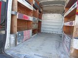 a white van that has some shelves in the back of it