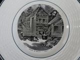 a black and white plate with a picture of a man and a dog