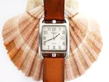 a watch that is sitting on top of a shell
