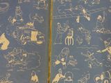 a blue book with drawings of people and animals on it
