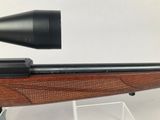 a close up of a rifle with a scope on it