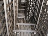 a room with many racks of metal items in it